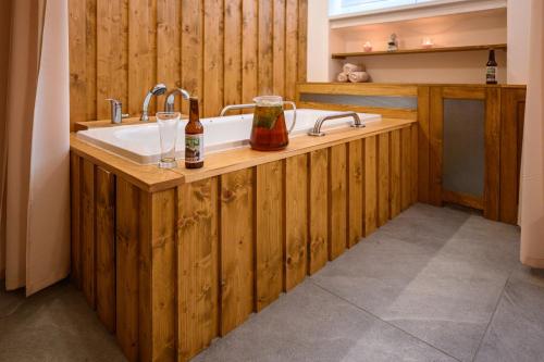 a bathroom with a bath tub with a sink at Lázně Meziboří in Meziboři
