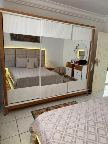 a bedroom with a large bed and a mirror at honey moon zeinbe 3 in Hammamet