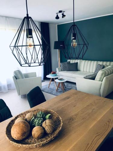 a living room with a table with a bowl of vegetables at Wanderlust Chiemgau in Bad Endorf