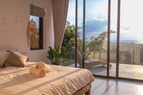 a bedroom with a bed with two towels on it at InnSpire Villa - Breathtaking Sunset View in Hinkong