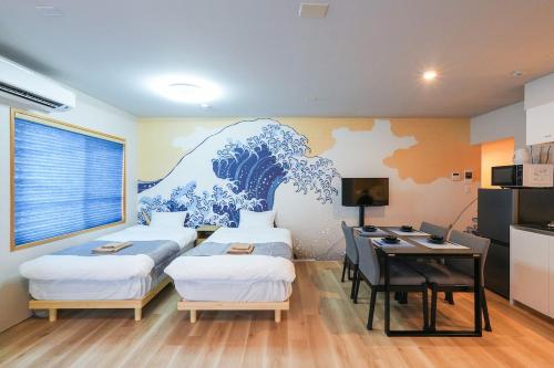 a room with three beds and a desk with a computer at Seed INN Haneda Terrace 201 in Tokyo