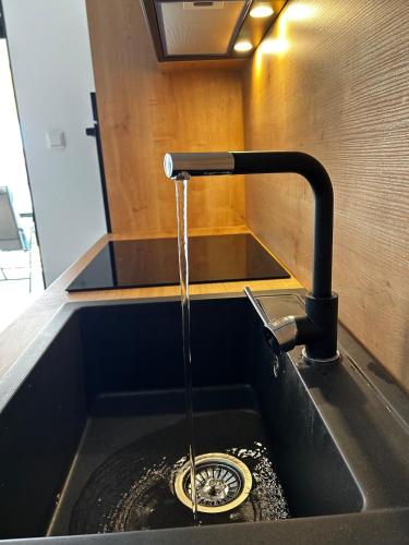 a kitchen sink with a water fountain at Apartment Sunset - Private Pool & Sea View in Bar