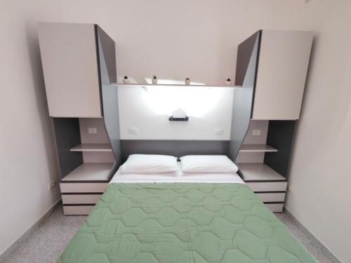 a small room with a bed and shelves at Le Zagare Case Vacanza in Cropani