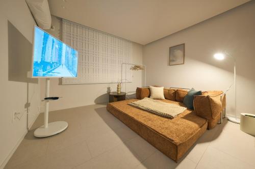 a living room with a couch and a flat screen tv at Stay Seongsu Villa in Seoul