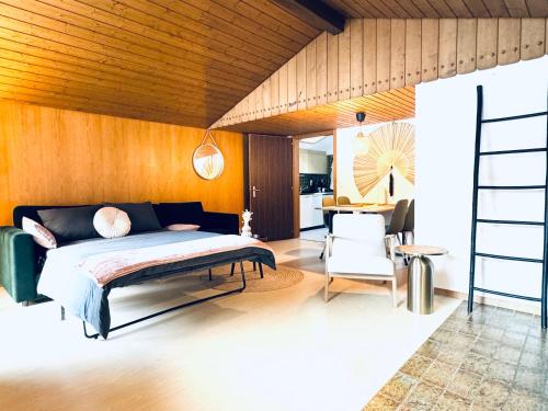 a bedroom with a bed and a wooden wall at Bergtraum Suite in Kandersteg