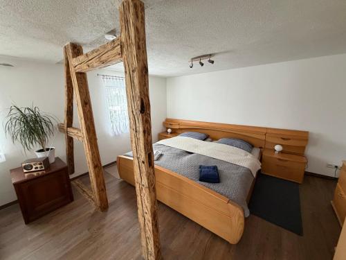 a bedroom with a wooden bed with blue pillows at Ferienwohnung Lippmann in Großhartmannsdorf