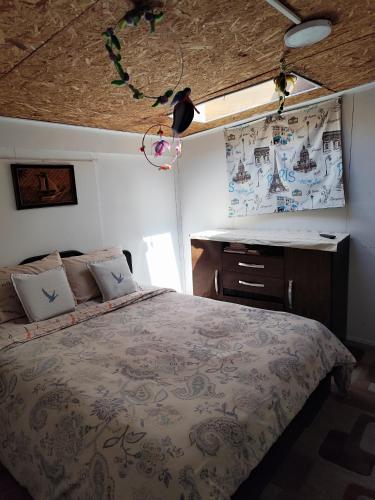 a bedroom with a bed and a desk in it at Hostal La Casa de Sandrita in Castro