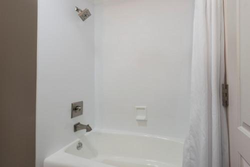 a white bathroom with a sink and a shower at Hotel 1550 - SFO Airport West in San Bruno