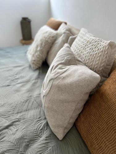 an unmade bed with two pillows on top of it at Guesthouse in Neuhäusel