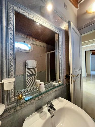 a bathroom with a sink and a mirror at Palazzo Sottile Meninni - CLASSIC ROOMS EXPERIENCE in Gravina in Puglia