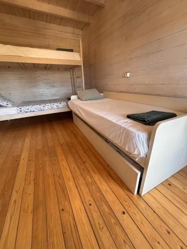 a bedroom with two bunk beds and a wooden floor at Casa na Colina in Almancil