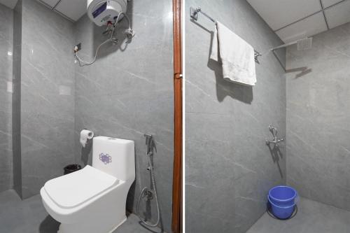 a bathroom with a toilet and a shower at Banquesta Suites in Noida