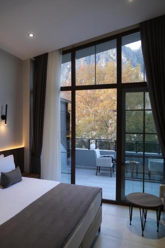 a bedroom with a bed and a large glass window at 1921 justa sefa otel in Amasya