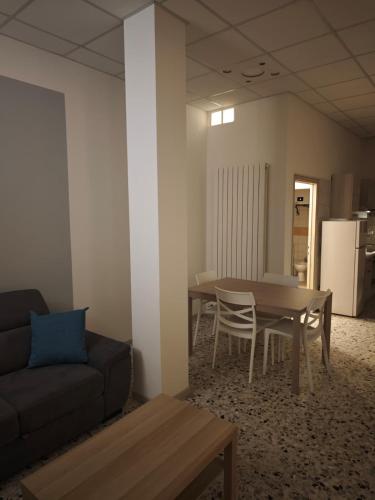 a living room with a couch and a table at Arlecchino Rooms in Santa Maria Codifiume