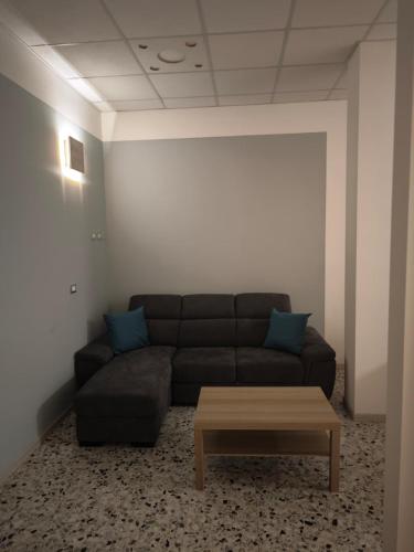 a living room with a couch and a coffee table at Arlecchino Rooms in Santa Maria Codifiume