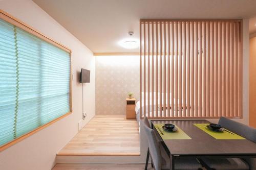 a dining room with a table and a large window at Seed INN Haneda Terrace 203 in Tokyo