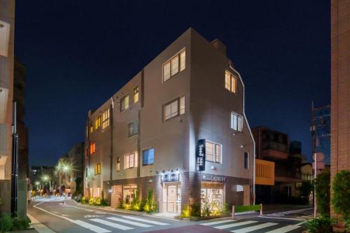 a large building on a city street at night at Seed INN Haneda Terrace 203 in Tokyo