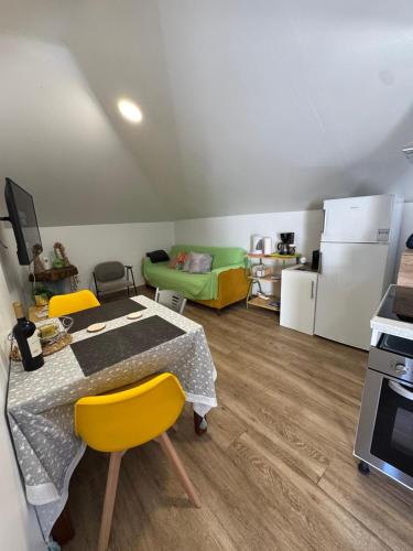 a kitchen with a table and yellow chairs in a room at House in the Heart of Funchal with big balcony in Funchal