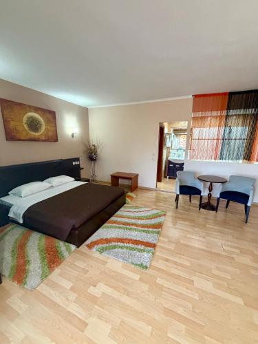 a bedroom with a bed and a desk and a table at Kornilios Istron Hotel in Giannitsa