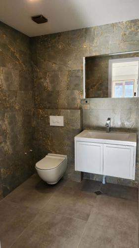 a bathroom with a toilet and a sink at Harmony house in Bakuriani