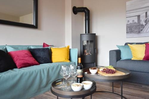 a living room with a couch and a fire place at Ferienhaus Barke 17 in Tinnum