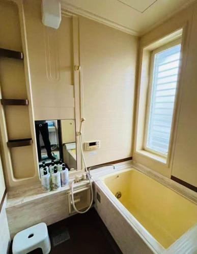 a bathroom with a large tub and a window at Biwa Takashima BBQ可 近湖周道路 in Takashima