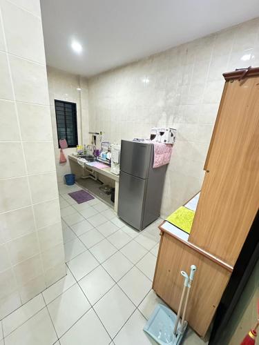 a kitchen with a counter and a refrigerator in it at Easy stay kk in Kota Kinabalu