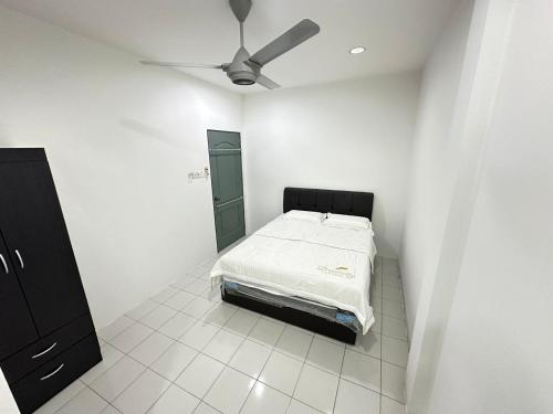 a bedroom with a bed and a ceiling fan at Easy stay kk in Kota Kinabalu