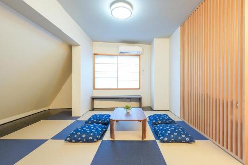a room with a table and blue pillows at Seed INN Haneda Terrace 301 in Tokyo