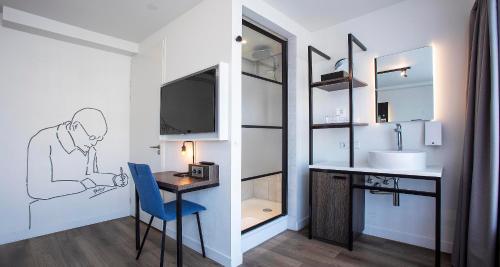 a bathroom with a desk and a sink with a drawing on the wall at Berlage Hotel, BW Signature Collection in The Hague