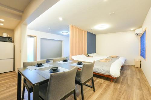 a room with a bed and a table and chairs at Seed INN Haneda Terrace 301 in Tokyo