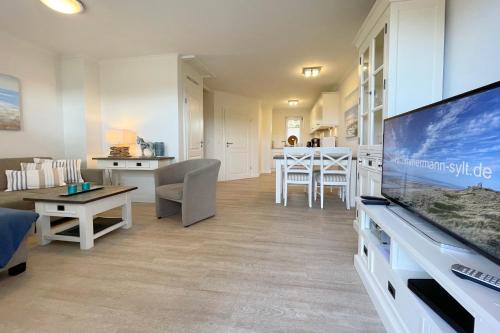 a living room with a large flat screen tv at Ferienhaus Alte Dorfstraße 20 in Tinnum