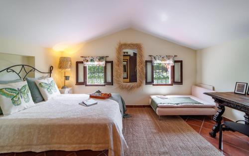 a bedroom with a large bed and a piano at Sierra Blanca Bungalow in Marbella