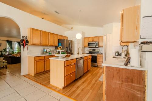 a large kitchen with wooden cabinets and wooden floors at Flint and Kingscrest, LLC - Private Rooms in Shared Home in Orlando