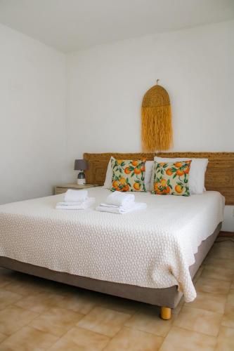 a bedroom with a large bed with white sheets at Oura Parque Apartamentos Turisticos in Albufeira