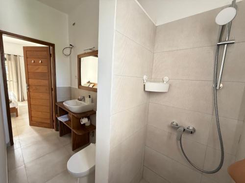 a bathroom with a shower and a sink at ZenKai Mamelles Hotel in Dakar