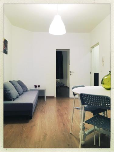 a living room with a couch and a table at Second floor at home in Brussels