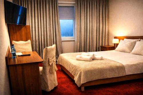 a hotel room with a bed with towels on it at Motel Jaśminowy Dworek Człekówka 67 B in Człekowka