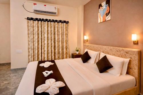 a bedroom with a large bed with towels on it at Hotel Sai 9 Heaven A Quality Apartment Perfect for Families in Shirdi