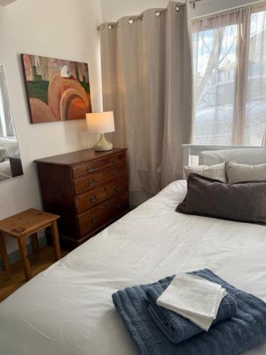 a bedroom with a bed and a dresser and a window at Large cosy home with garden, excellent location! in Galway