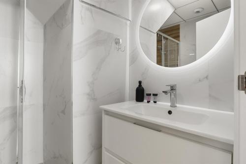 a white bathroom with a sink and a mirror at Fuengirola I in Fuengirola