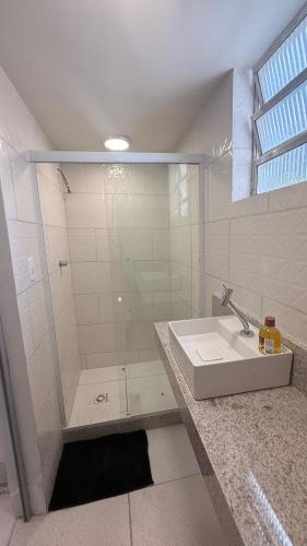 a bathroom with a shower and a sink at Studio de Hóspedes - 150m da Praia in Rio de Janeiro