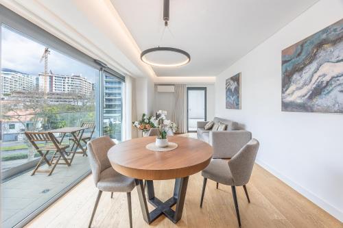 a living room with a table and chairs at Acqua Residence in Funchal