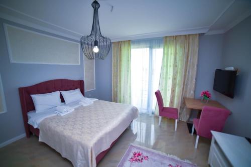 a hotel room with a bed and a desk and a room at Adonis 204 in Zlatibor