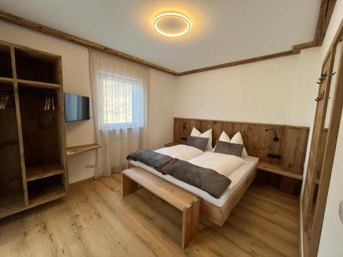 a bedroom with a large bed and a tv at Mountain River Apartment in Chienes