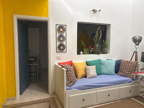 a couch with colorful pillows on it in a room at El Charco Rooms in Arrecife