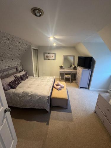 a bedroom with a bed and a desk in it at Sea View House in Dalkeith