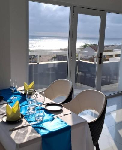 a dining room with a table with a view of the ocean at Hotel Midotel Seaview in Pointe-Noire