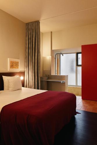 Llit o llits en una habitació de Hotel Pilar