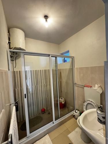 a bathroom with a shower and a toilet at Cozy Home with Terrace Views! in Ponta do Sol